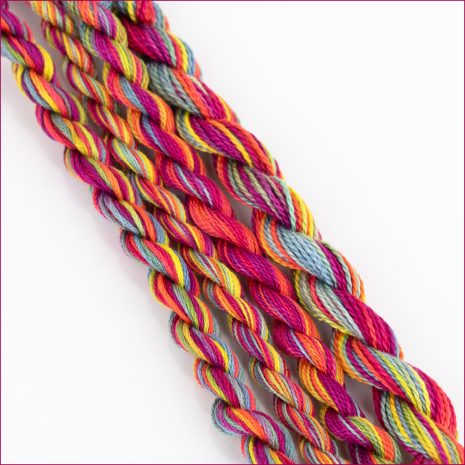 Colour Complements Colour 110 variegated perle cotton thread, color #110, in vibrant pink, orange, yellow, and blue hues.