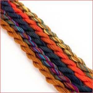 Size 5 perle cotton sampler threads in warm, earthy tones,