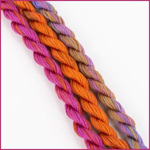 variegated cotton embroidery floss in shades of pink, orange, and purple.