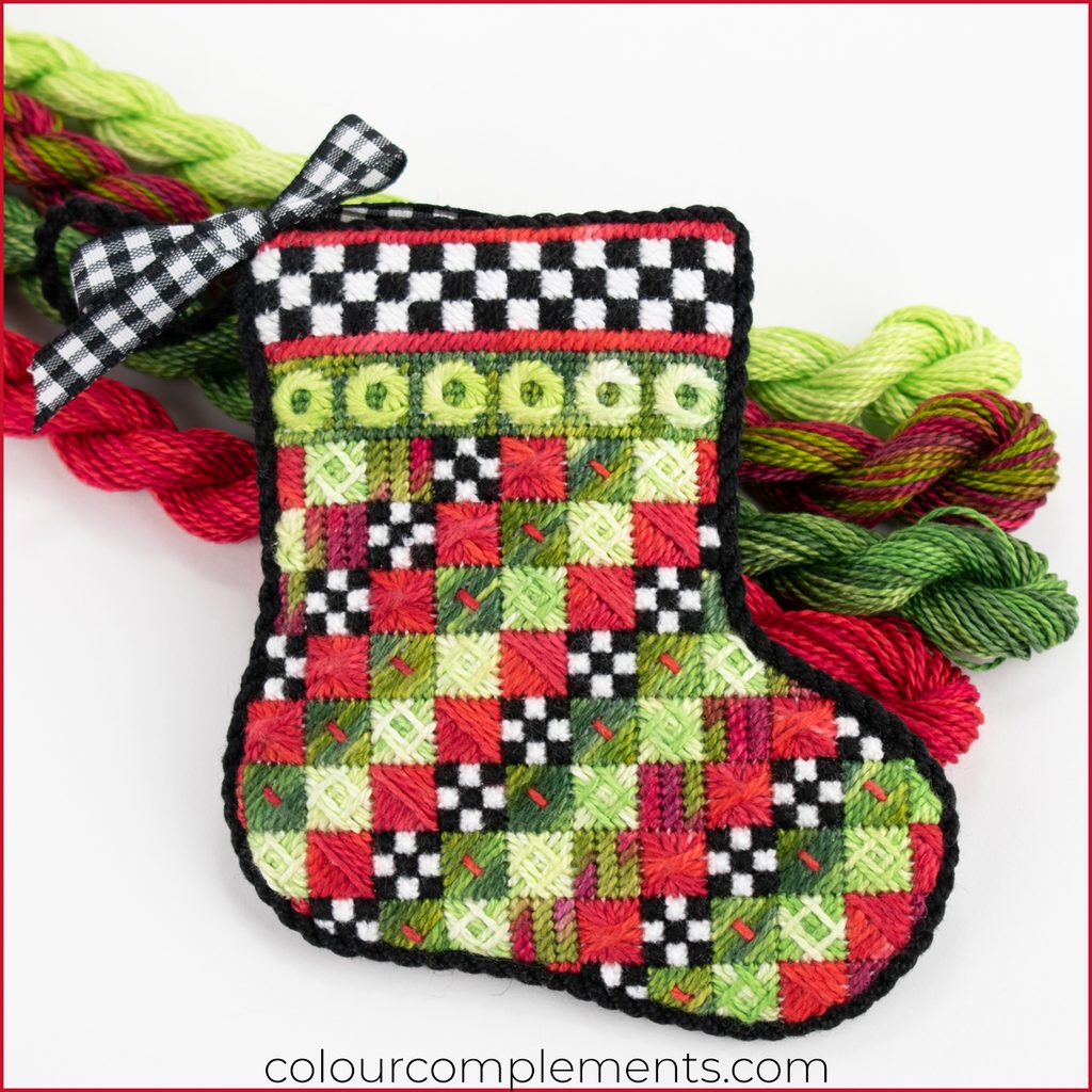 Christmas stocking needlepoint in a non-traditional christmas colour palette with hand-dyed threads