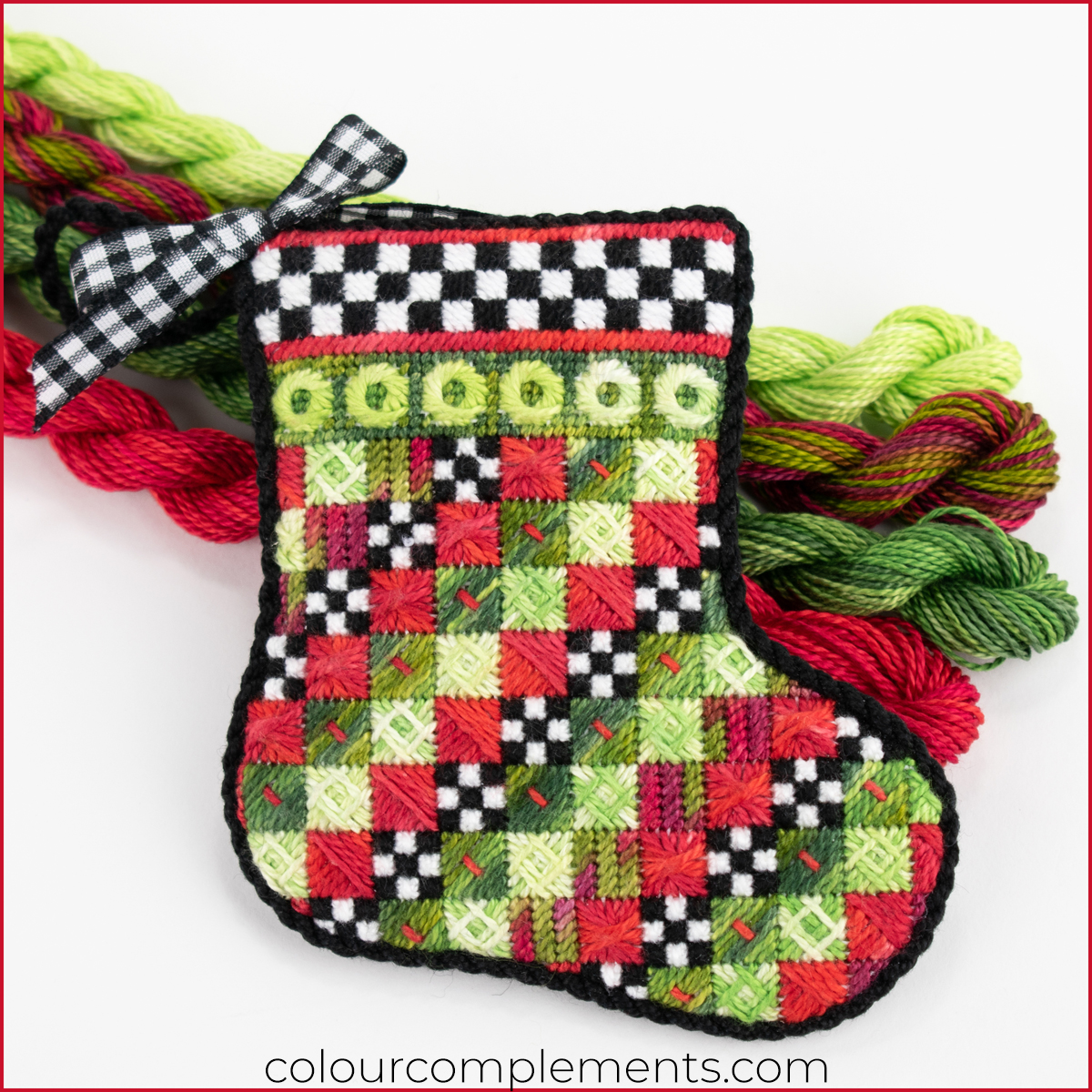 Christmas stocking needlepoint in a non-traditional christmas colour palette with hand-dyed threads
