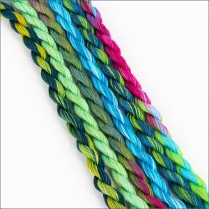 size 12 perle cotton embroidery thread in various shades of green, blue, and pink.