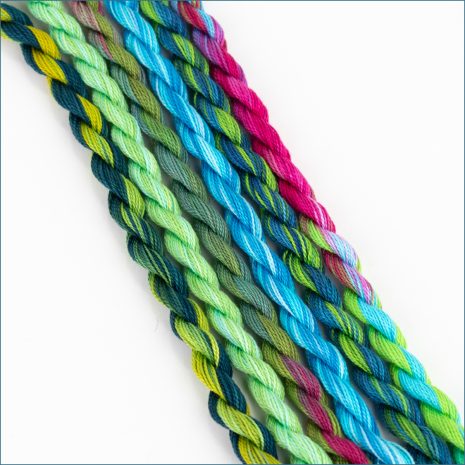 size 12 perle cotton embroidery thread in various shades of green, blue, and pink.