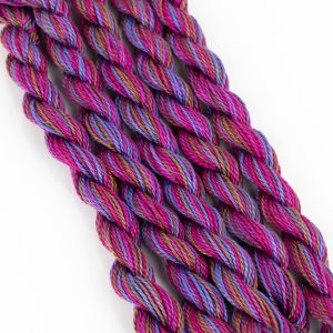 Size 5 Perle cotton in shades of red violet, purple and brown.